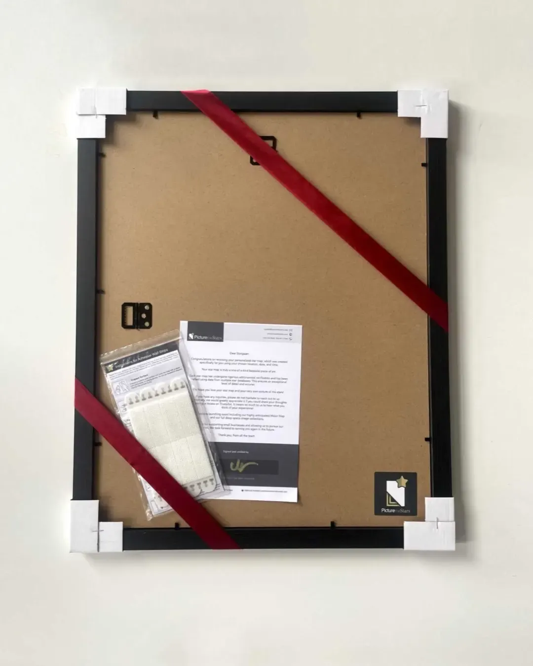 Frame back with ribbon, hanging strips and signed verification letter