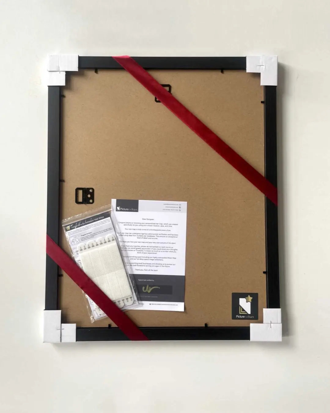 Frame back with ribbon, hanging strips and signed verification letter